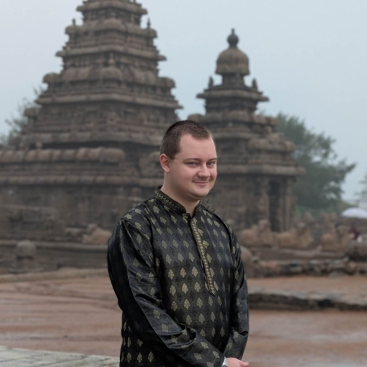 David Berdik standing in front of stone temples